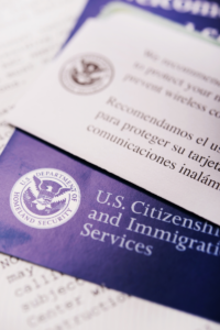 Close-up of documents from the U.S. Department of Homeland Security and U.S. Citizenship and Immigration Services, partially overlapping each other.